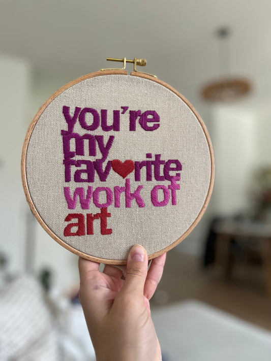 A hand embroidered hoop with the quote &quot;you&#39;re my favourite work of art&quot;